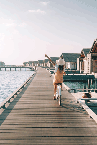 Girl cycling at hotel in Maldives